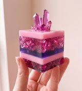 Handmade pink and purple resin cake with light catching through clear layers