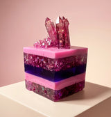 Resin faux cake close-up showing clear layers, crushed glass and epoxy crystal cluster on top